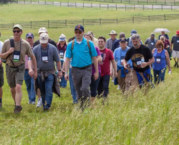 A group of tourists walking through a battlefield