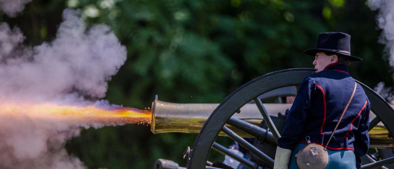 Living history volunteers portraying members of Battery B, 4th US present an artillery demonstration at Gettysburg National Military Park, Pa.