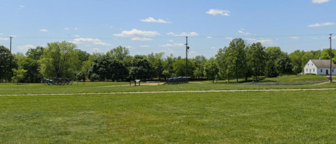 This is a photograph of a battlefield's green grass. 